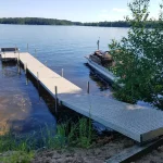 sectional dock in lake surrounded by foliage on beach