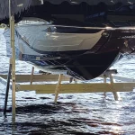 front and bottom view of boat lifted by boat lift