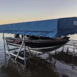 blue canopy on boat lift holding boat