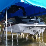 white boat lifted covered with blue canopy