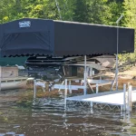 black canopy over boat next to custom portable dock