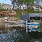 a boat stored on a custom boat lift with a custom canopy