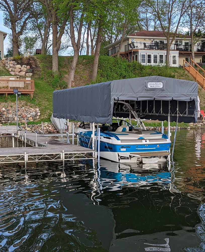 a boat stored on a custom boat lift with a custom canopy