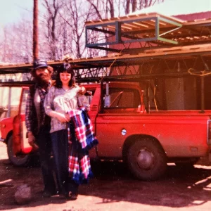 vintage photo of couple in front of red truck